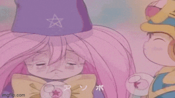 a girl with pink hair is kissing a boy with a blue hat .