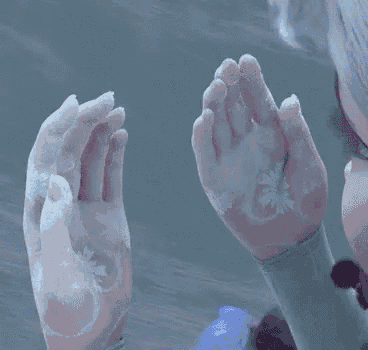 a close up of a person 's hands covered in snow