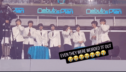 a group of men are standing in front of a banner that says debut 's plan