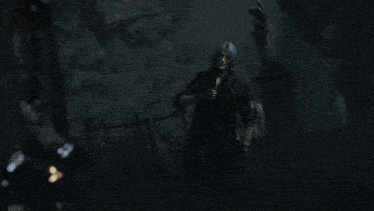 a man in a knight 's armor stands in a dark cave