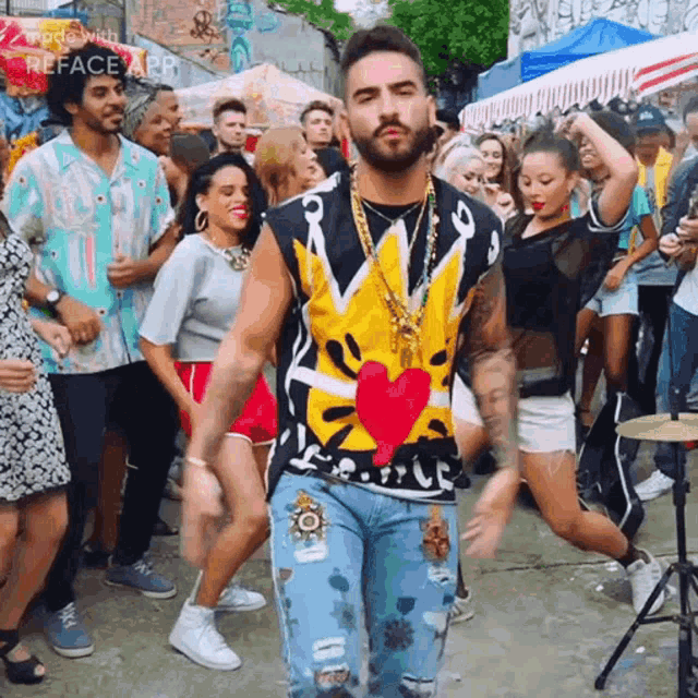 a man with a beard is dancing in front of a crowd