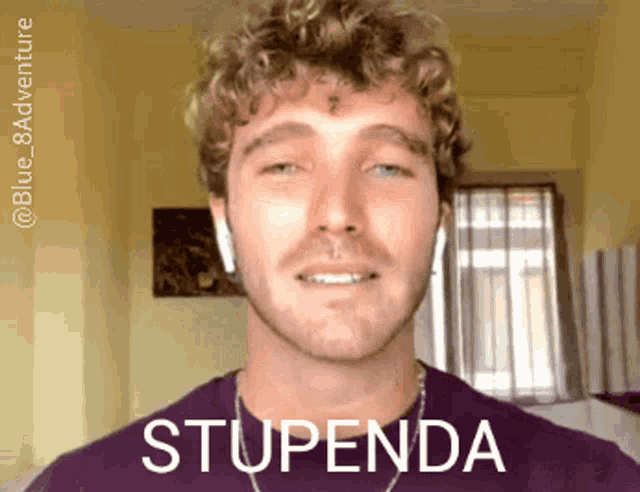 a man with curly hair is wearing ear buds and has the word stupenda on his face