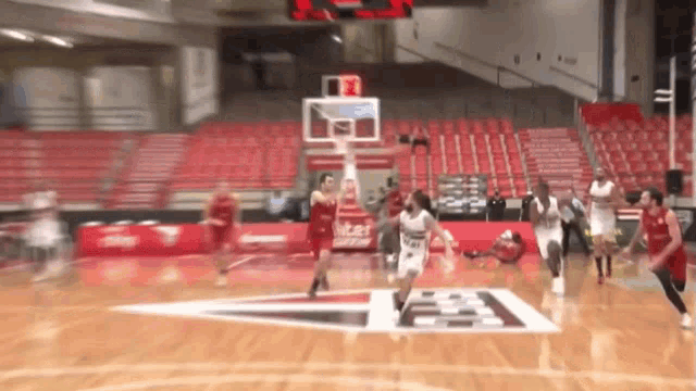 a blurred image of a basketball game with a coca cola logo in the background