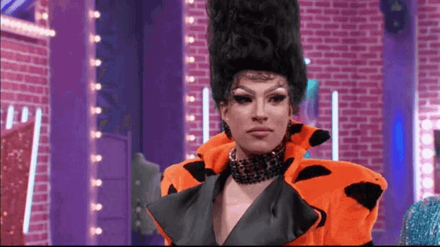a drag queen wearing a flintstones costume and a necklace