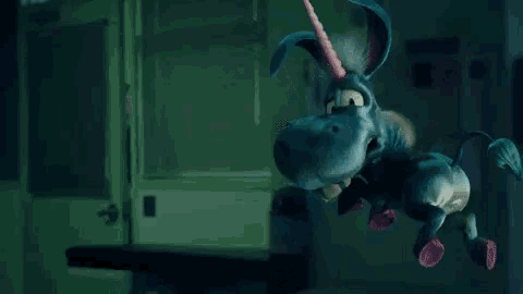 a cartoon unicorn is flying through the air in the dark .