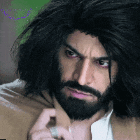 a close up of a man with a beard and long hair with a gif factory logo in the corner