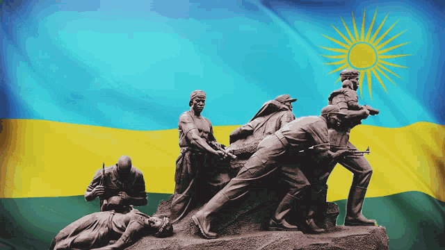 a statue of soldiers in front of a flag with the sun on it