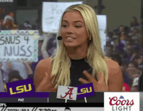 a woman with a sign that says snus 4 nuss on it