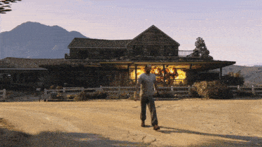 a man standing in front of a burning house in a video game