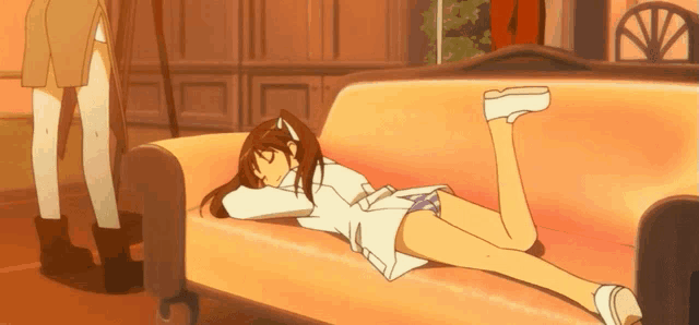a girl is laying on a couch with her legs up