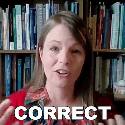 a woman is standing in front of a bookshelf and says correct