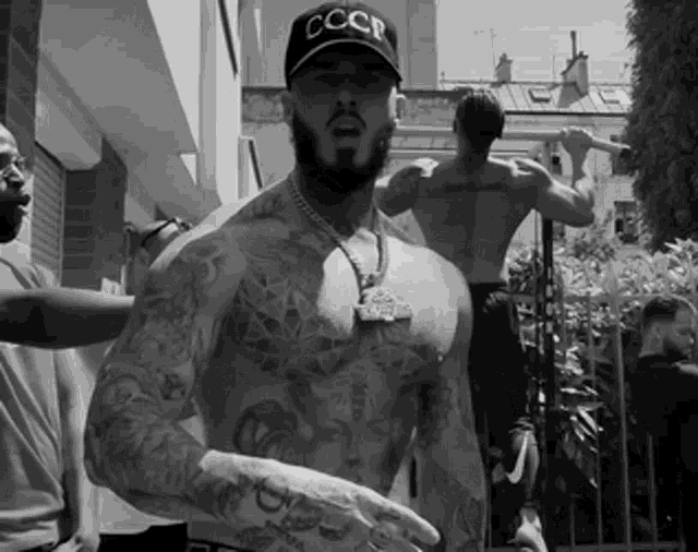 a shirtless man wearing a hat with cccp on it