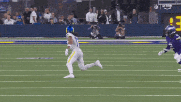 a football player wearing a number 17 jersey is running on the field