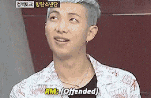 a close up of a man 's face with the words `` rm : ( offended ) '' written on it .