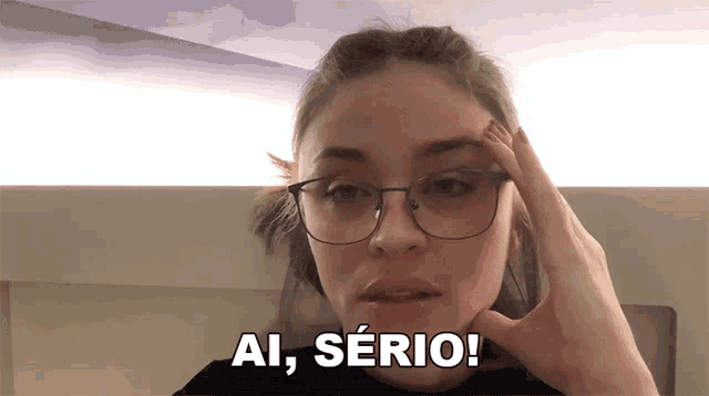 a woman wearing glasses says ai serio in a foreign language