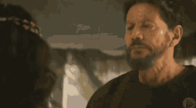 a man and a woman are kissing each other in a room .