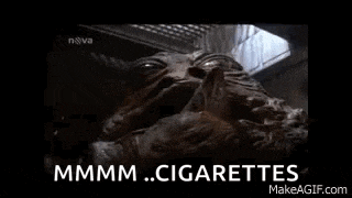 a close up of a statue of a monster with the words `` cigarettes '' written on it .