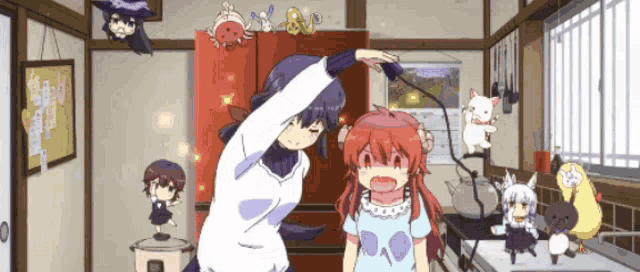a girl with red hair is standing next to another girl in a kitchen