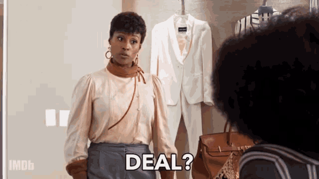 a woman standing in front of a mirror with the word deal written below her