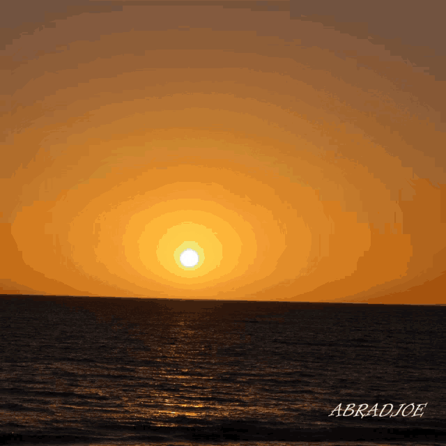 a photo of a sunset over the ocean was taken by abradjoe