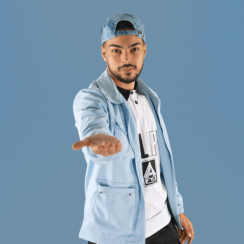 a man wearing a light blue jacket and a white shirt that says la on it