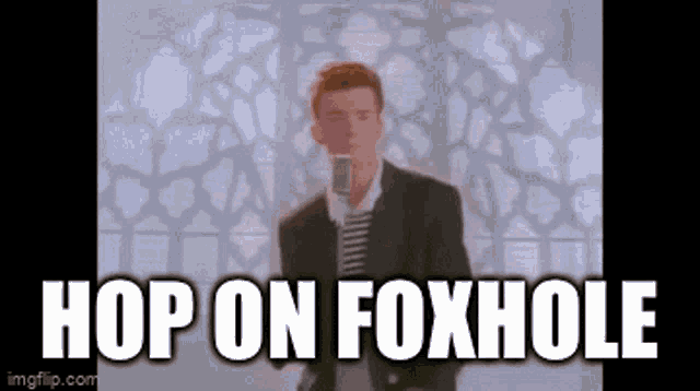 a man in a suit singing into a microphone with the words hop on foxhole below him .