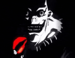 a black and white drawing of a clown 's face with a red tongue .