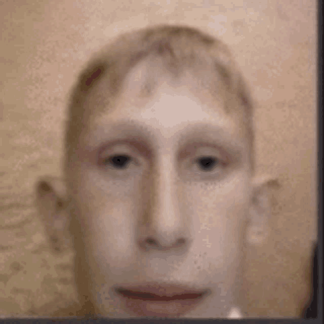 a blurry picture of a man 's face with a few spots on it