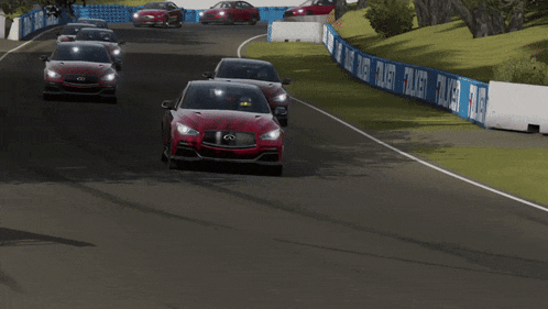 two red infiniti cars are driving on a track