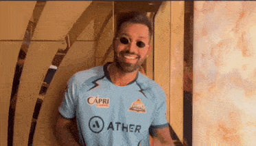 a man wearing sunglasses and a jersey that says ather