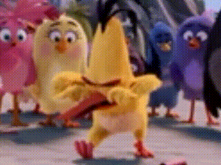 a group of angry birds standing next to each other on a sidewalk .