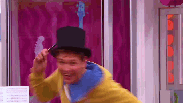 a man wearing a top hat and a yellow jacket