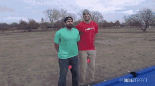 two men standing next to each other with dude perfect written on the bottom right