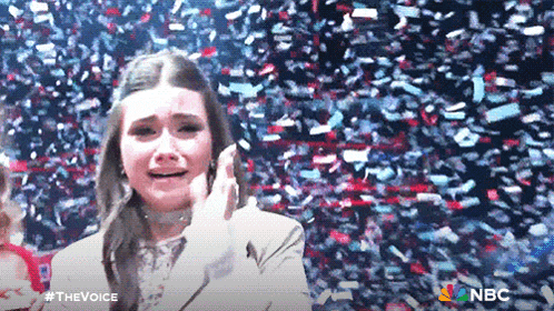 a woman is crying while confetti is falling around her and the words the voice are on the bottom