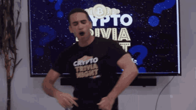a man wearing a shirt that says crypto trivia night is dancing