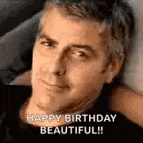 a man is laying on a bed with his head resting on his arm and a happy birthday message .