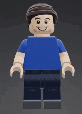 a lego man wearing a blue shirt and jeans is smiling