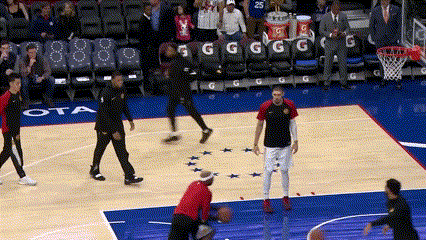 a basketball game is being played on a court with the word ota on the floor