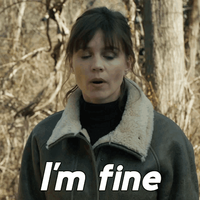 a woman in a jacket says i 'm fine in white letters