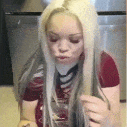 a woman with long blonde hair is wearing a red t-shirt that says rock on it