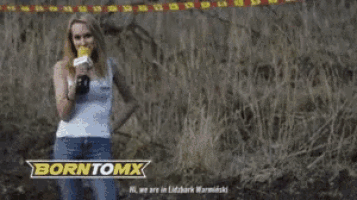 a woman is holding a microphone in front of a borntomx sign