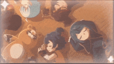 a group of anime characters are laying on the floor with a teddy bear in the middle .