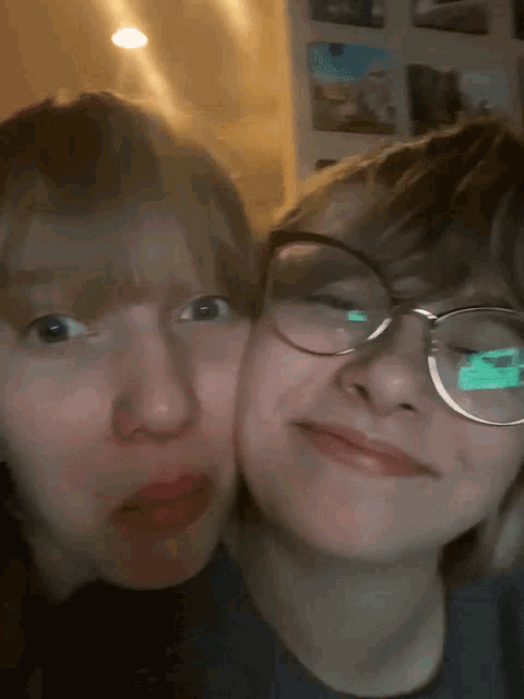 two girls with glasses are making funny faces