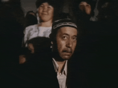 a man wearing a hat is talking on a phone