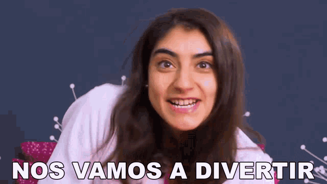 a woman is smiling with the words nos vamos a divertir behind her .