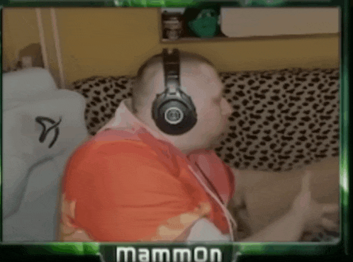 a man wearing headphones is sitting on a couch with a green frame that says mammon