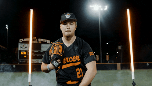 a baseball player wearing a black jersey with the number 21