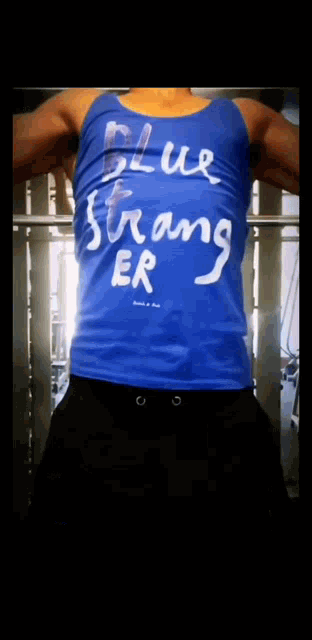 a man wearing a blue tank top that says " blue stronger "