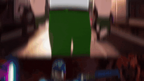 a person in green pants is riding a bicycle