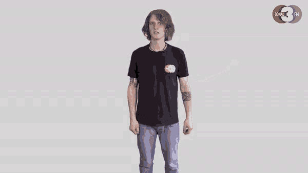 a man in a black shirt is dancing in front of a dohau fm logo